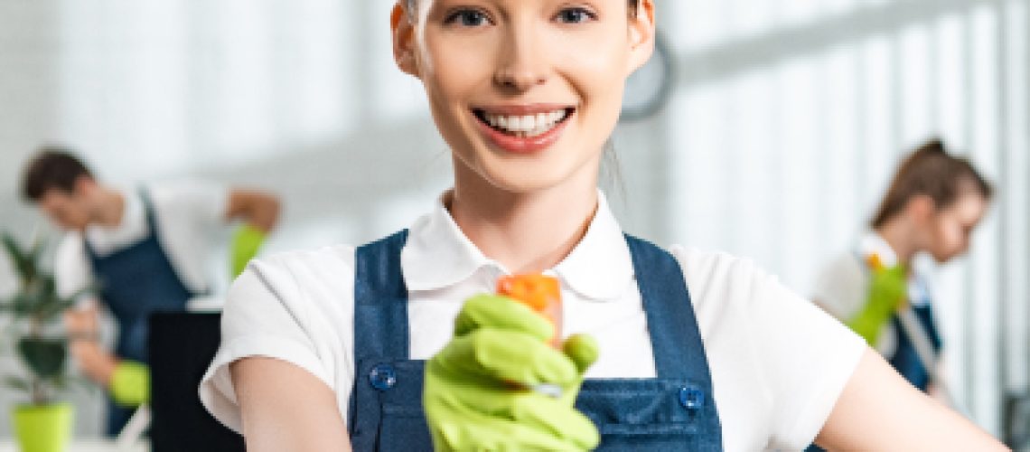 cheerful-cleaner-in-overalls-standing-with-hand-on-2022-12-16-21-16-05-utc-1.jpg